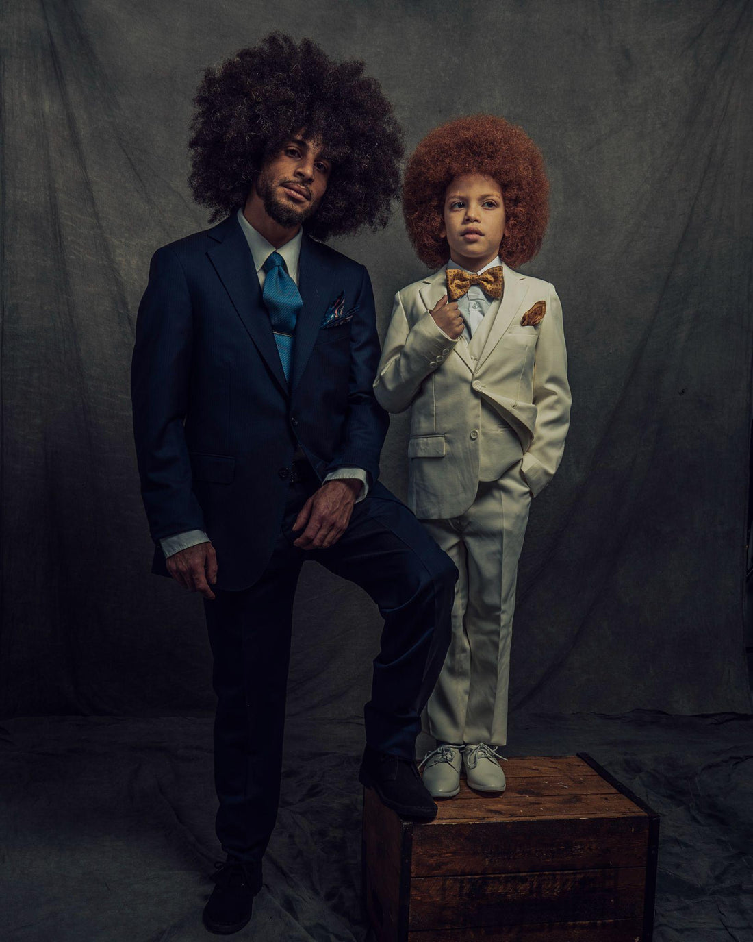 Father and son standing together in suits.