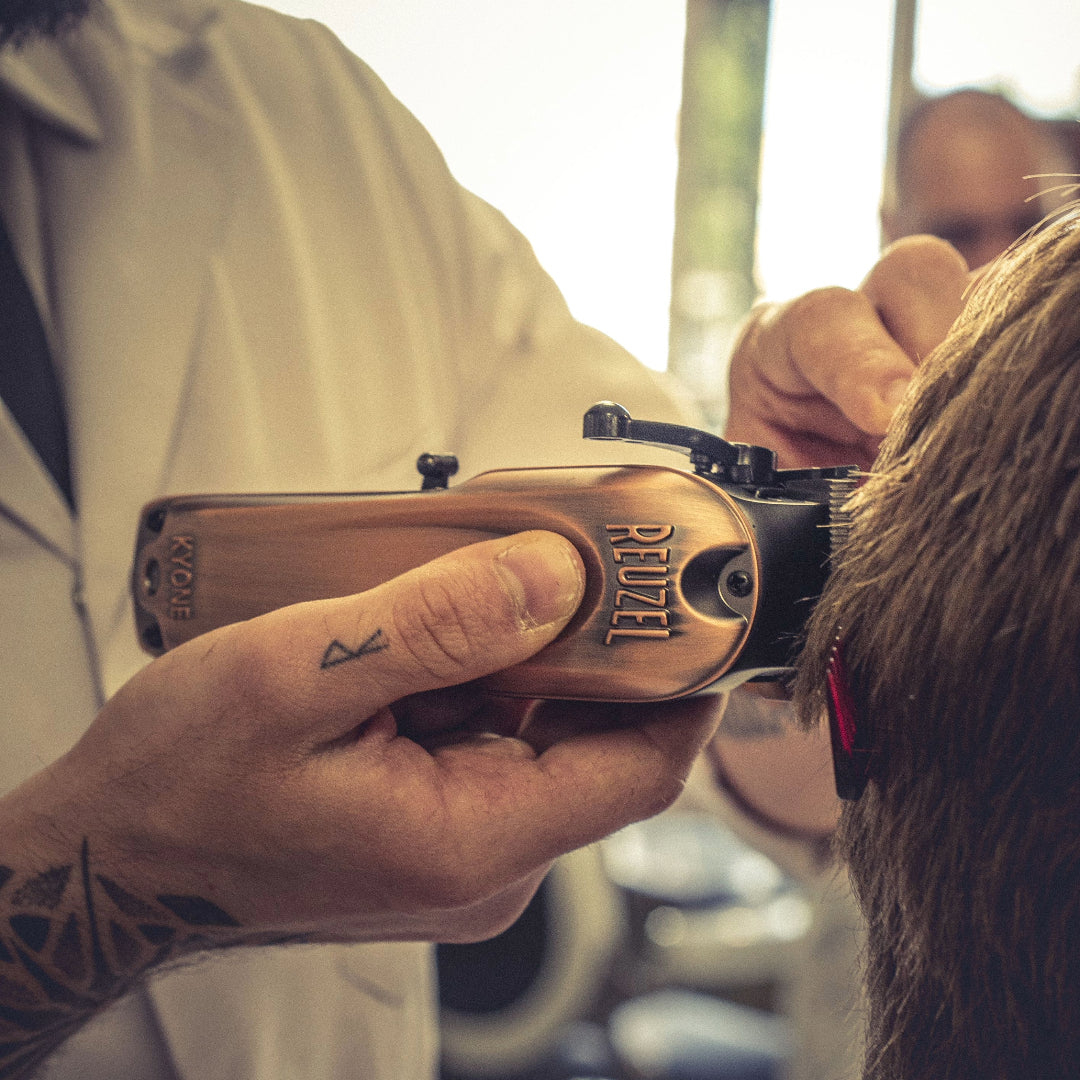 Barber using Reuzel Clippers